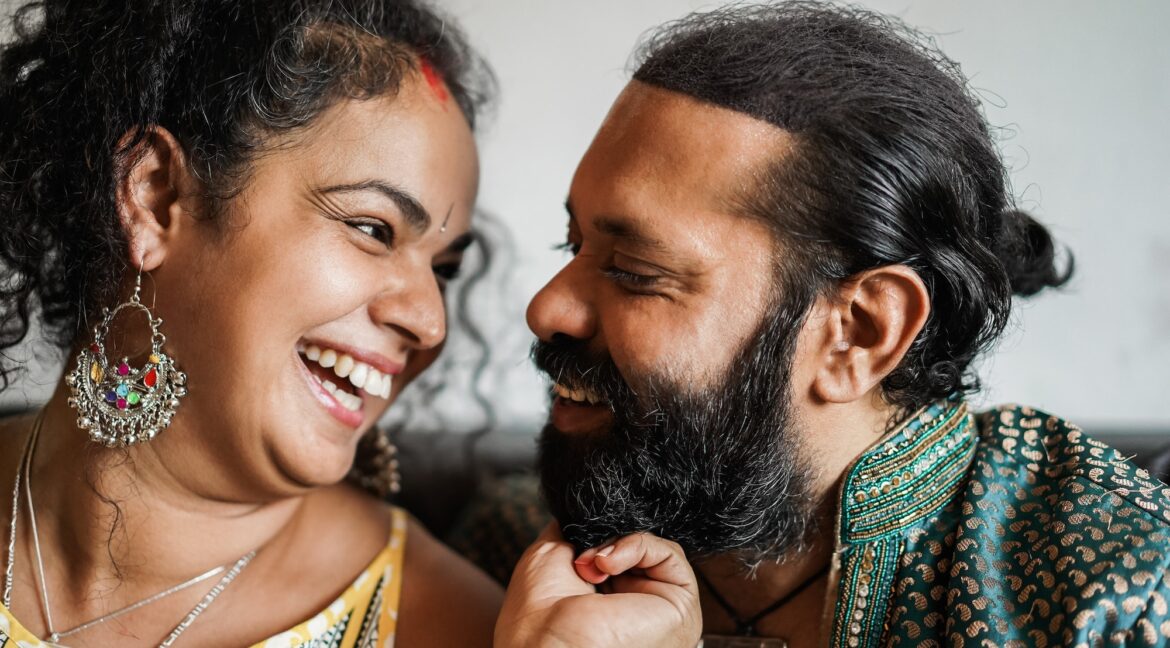 Indian couple having tender moments together indoors at home - Focus on woman face