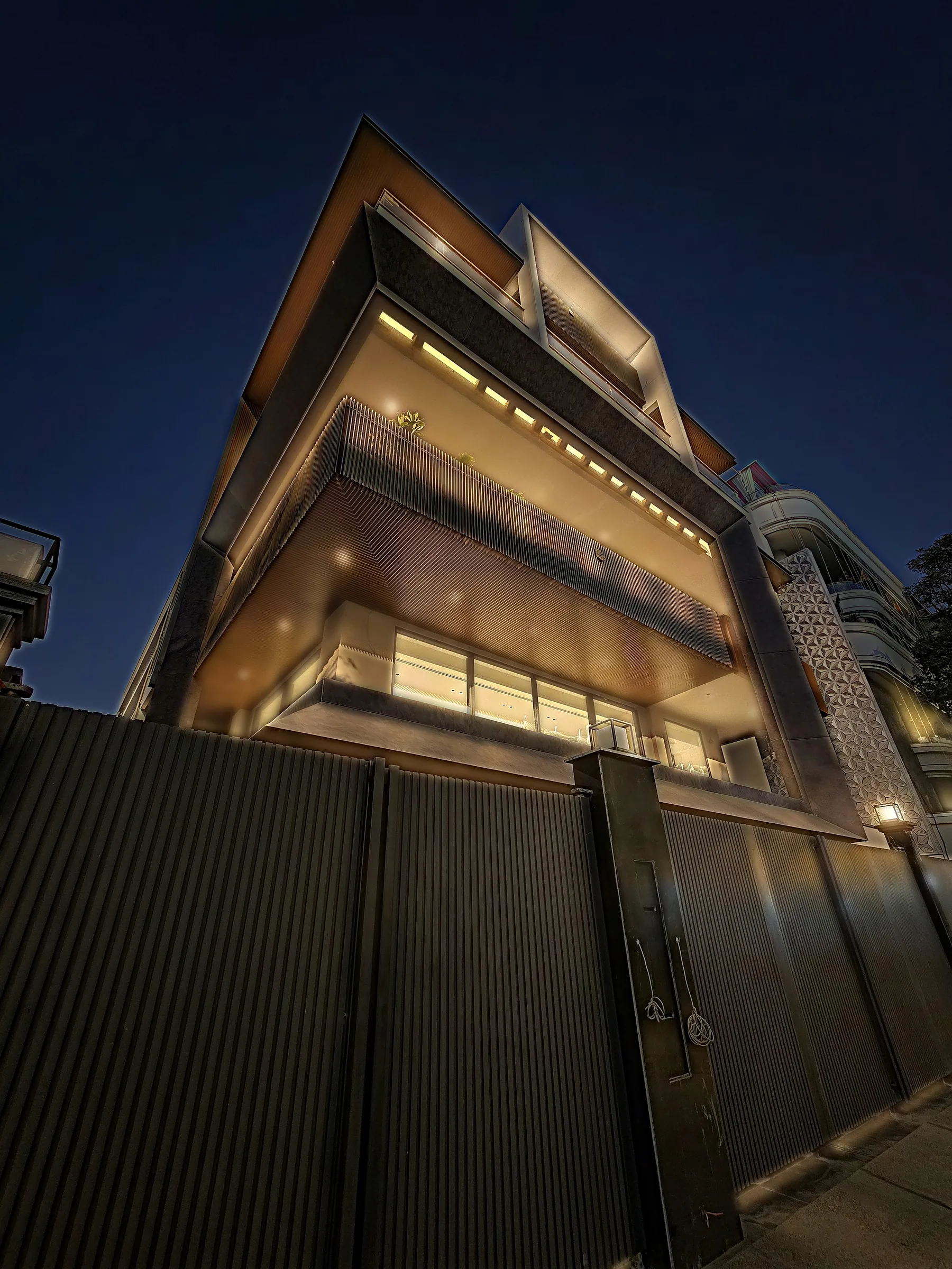 Exterior of an Ekum Homes builder floor in GK-1 (Greater Kailash I), South Delhi, with stone cladding, cantilevered balconies and a wood-slat soffit