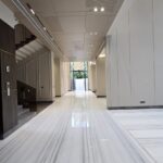 Entrance hall with floating staircase and marble flooring at an Indus Homes luxury villa