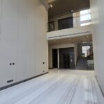 Double-height marble lobby with staircase and private lift in a duplex in Chanakyapuri, Malcha Marg, South Delhi