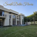 1,750 sq yard farmhouse for sale in Chattarpur, South Delhi — evening exterior with swimming pool and lawn