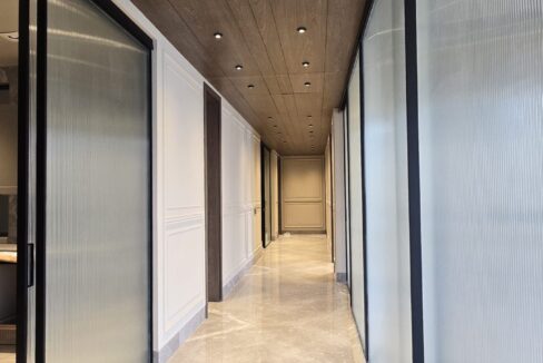 Indus Homes Wood Ceiling Fluted Glass Corridor