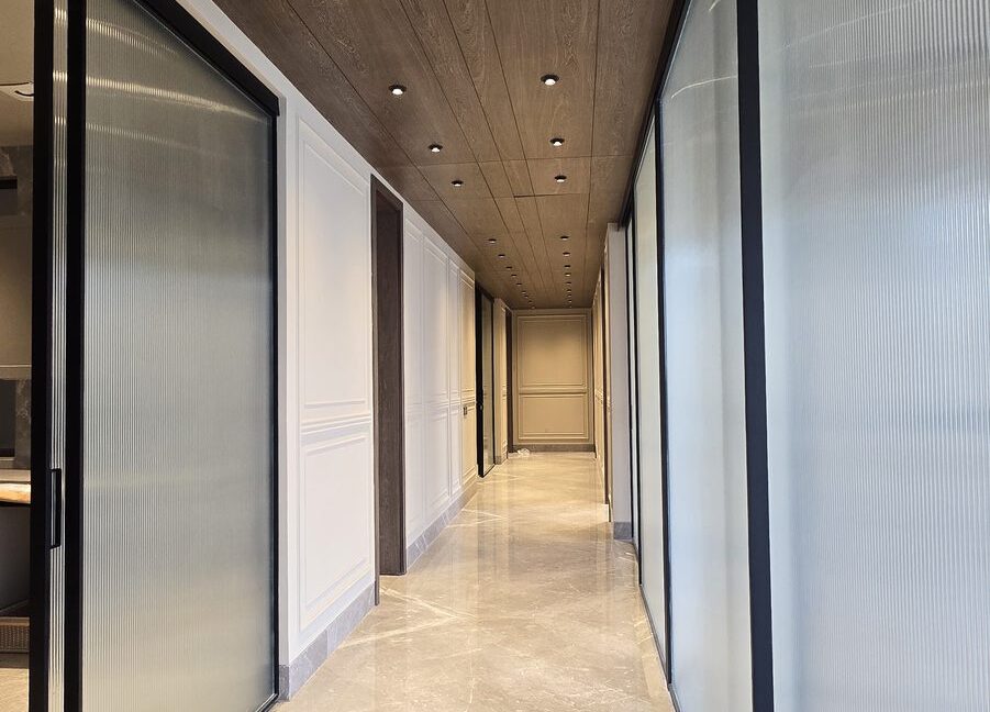 Indus Homes Wood Ceiling Fluted Glass Corridor