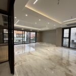 Open living room with floor-to-ceiling sliding windows and European marble flooring in the 4 BHK builder floor in Geetanjali Enclave, South Delhi.