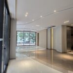 Drawing room with a curved marble inlay and cove-lit ceiling in a home by the developer of this 4 BHK in Panchsheel Park