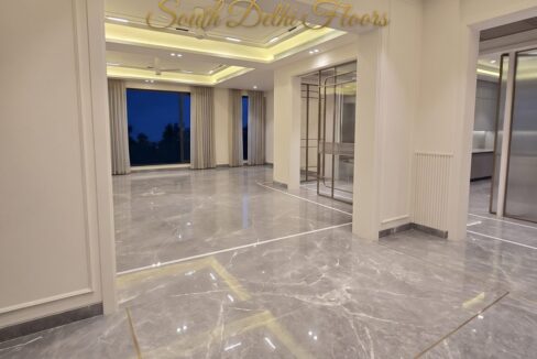 Dining room of the 4 BHK in Vasant Vihar, A Block, with a chandelier, Italian marble floor and cove lighting