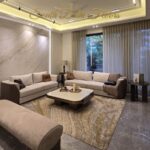 Furnished living room of the apartment in Vasant Vihar, B Block: Italian marble floor, marble feature wall and bespoke sofas