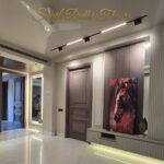 Living room with built-in shelving and artwork in a home by the developer of the biggest penthouse in South Delhi