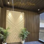 Entrance lobby with a sculpted feature wall and planters in a home by the developer of this builder floor in Maharani Bagh