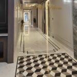 Entrance hall with tumbling-block marble inlay in a finished home by the developer of this corner duplex in GK-1