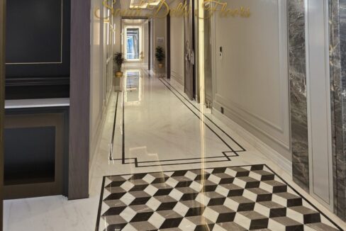 Entrance hall with tumbling-block marble inlay in a finished home by the developer of this corner duplex in GK-1