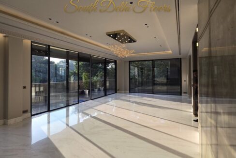 Corner home in Anand Niketan – sunlit living room with trees on two sides