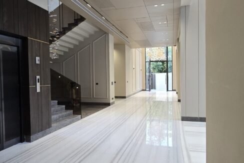 Marble hallway with a floating staircase in a home by the developer of this corner home in GK-2