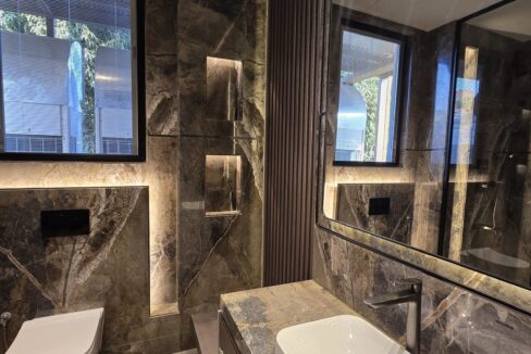 Ekum Homes Bathroom With Lit Shelf