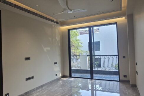Ekum Homes Bedroom With Cove-Lit Ceiling And Balcony Doors