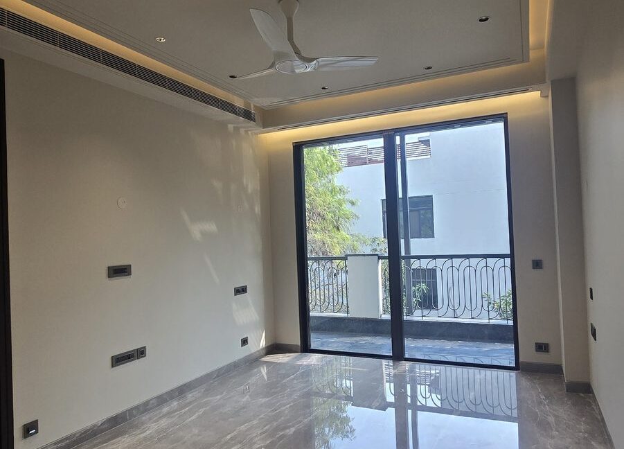 Ekum Homes Bedroom With Cove-Lit Ceiling And Balcony Doors