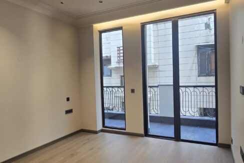 Ekum Homes Bedroom With Wood Flooring And French Doors
