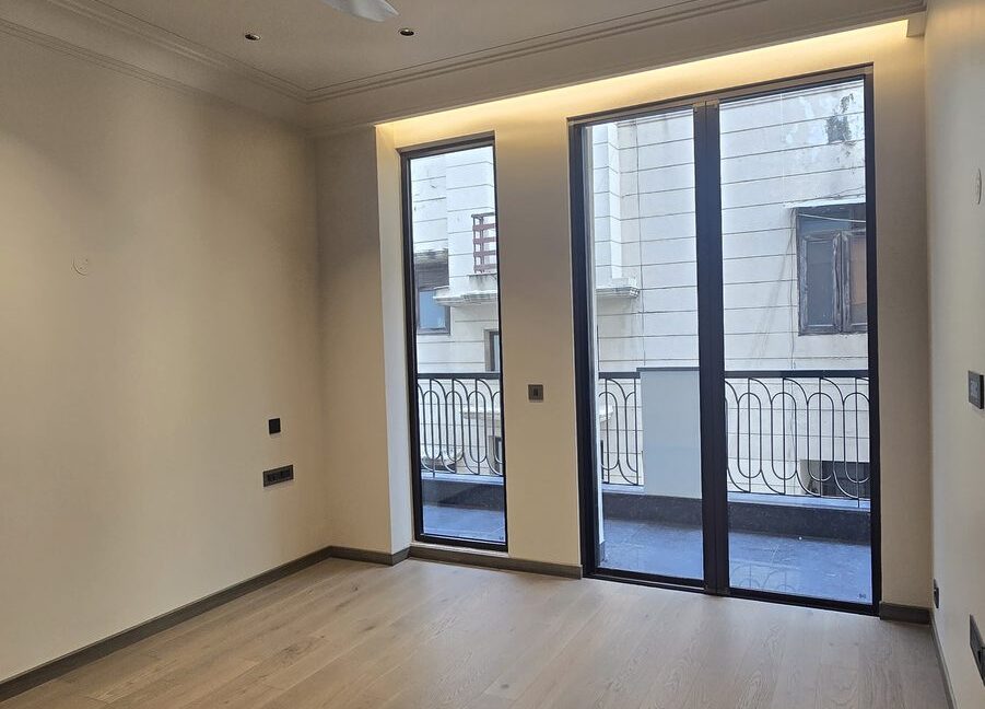 Ekum Homes Bedroom With Wood Flooring And French Doors