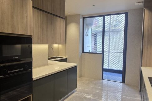 Ekum Homes Galley Kitchen With Built-In Appliances