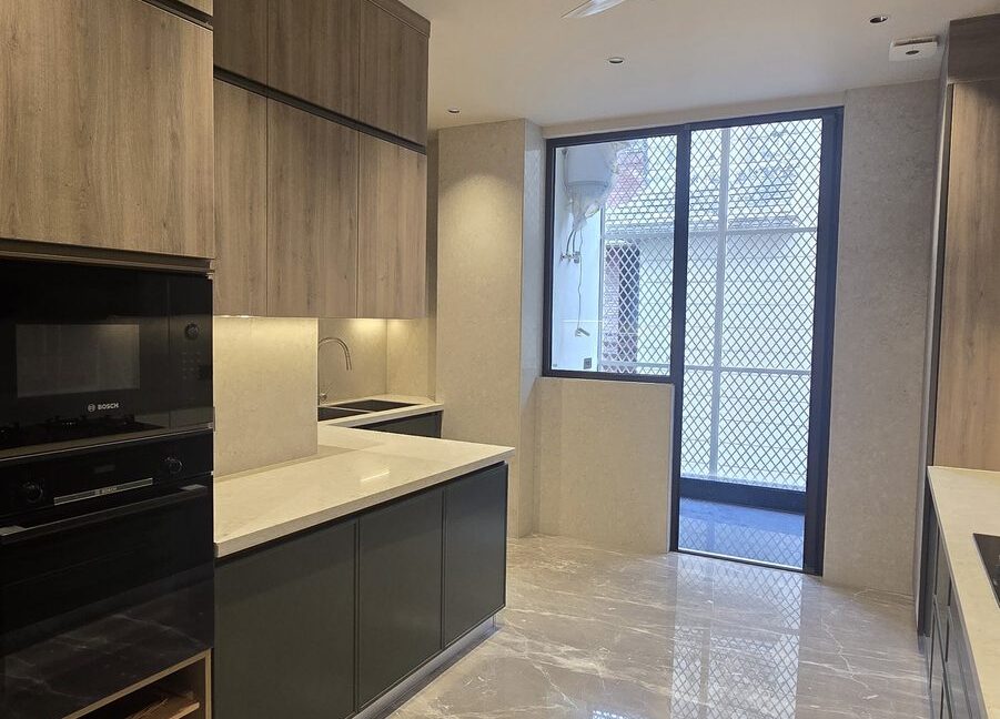 Ekum Homes Galley Kitchen With Built-In Appliances