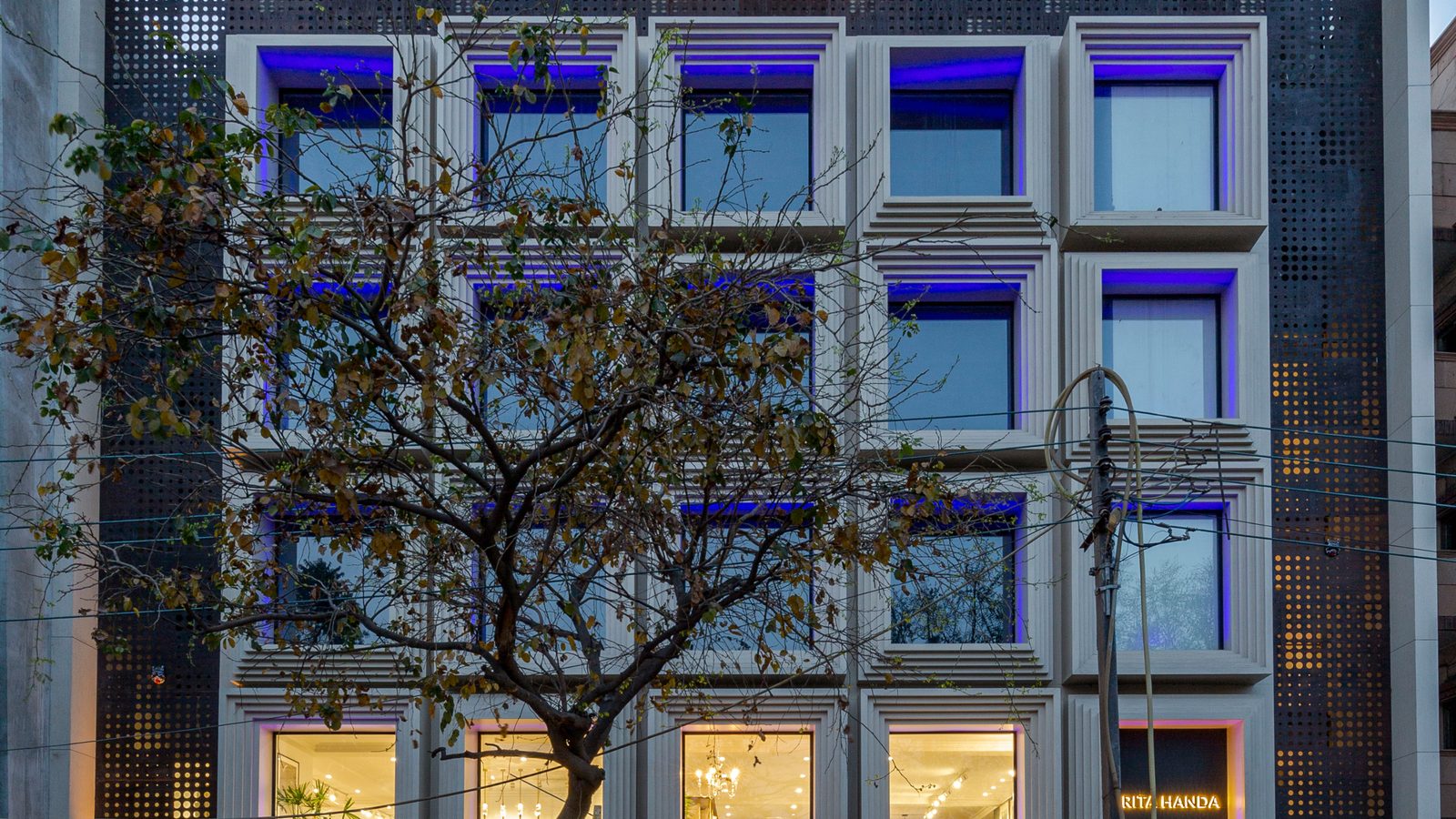 D-11 Defence Colony, a Katarias (Kataria Buildcon) building with a blue-lit grid facade, home to the Katarias office