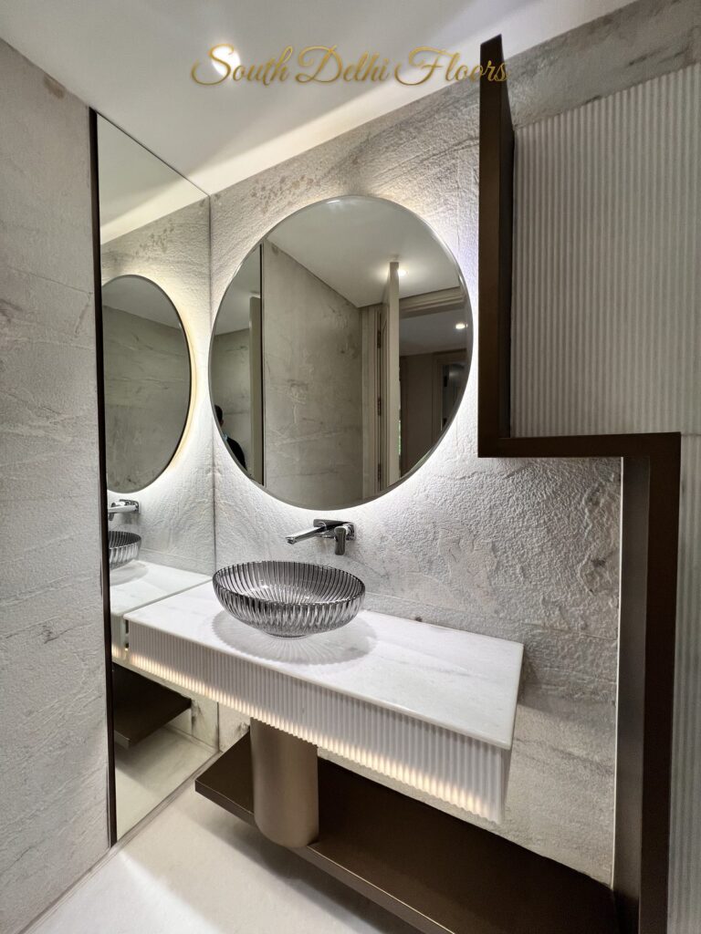 Powder room vanity with a crystal-cut vessel basin, wall-mounted mixer and LED underglow at a Katarias luxury builder floor in South Delhi by Sandeep Kataria