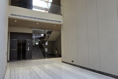 Double-height lobby with a private lift in a home by the developer of this north-facing home in GK-1