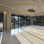 Sunlit marble living room finished by the developer, the standard planned for this builder floor in Maharani Bagh