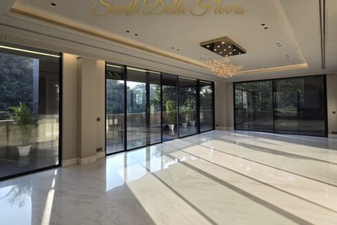 Sunlit marble living room finished by the developer, the standard planned for this builder floor in Maharani Bagh