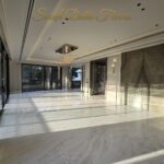 Bright marble living room finished by the developer, the standard planned for this park-facing duplex in Maharani Bagh