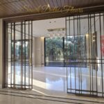 Bronze-grid sliding entrance doors in a finished home by the developer of the park-facing floors in GK-1