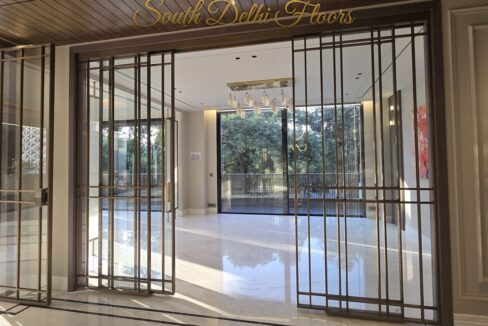Bronze-grid sliding entrance doors in a finished home by the developer of the park-facing floors in GK-1