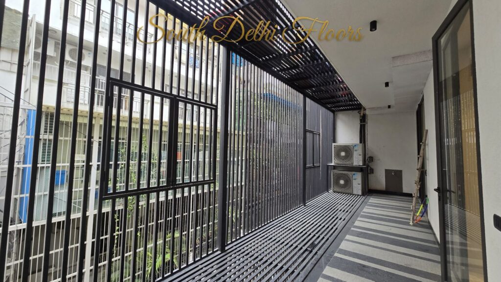 Balcony with a vertical louver privacy screen and striped granite floor at an RPB Homes JCR Homes luxury home in South Delhi by builders Mahavir Bihani and Rajat Bihani