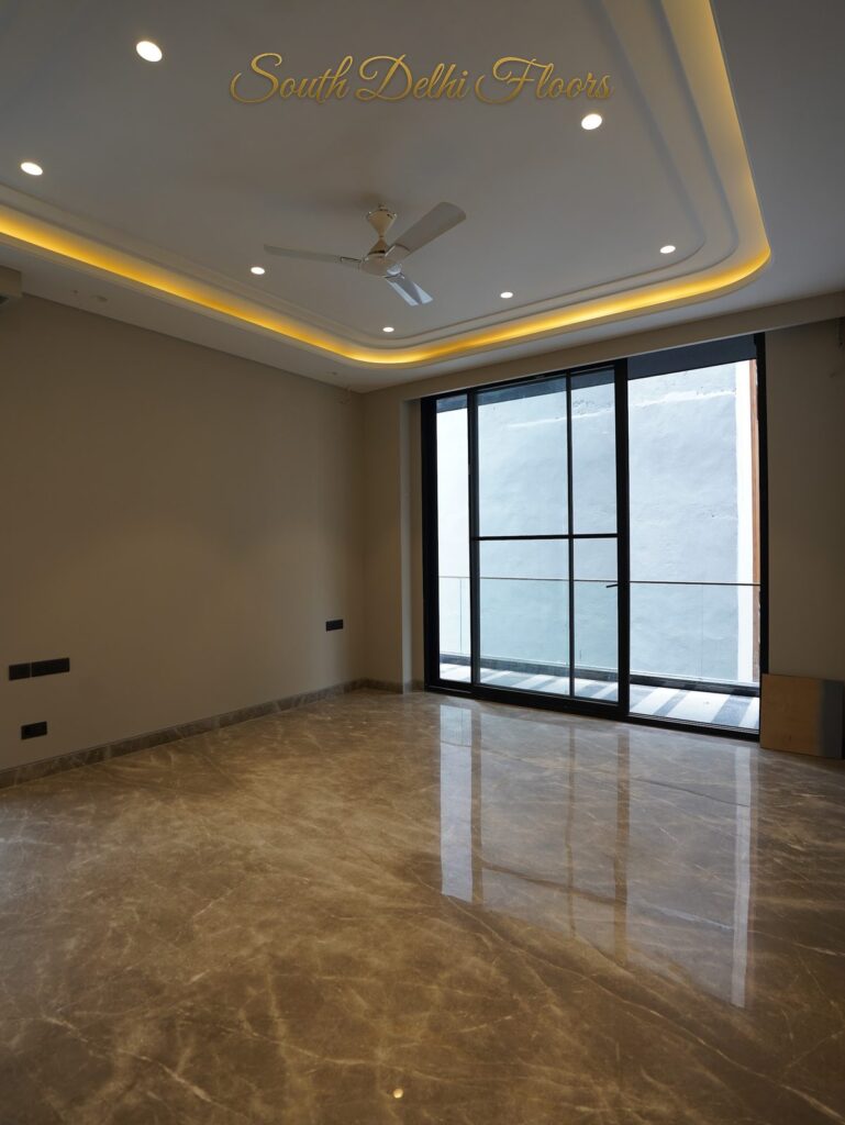 Bedroom with a curved cove-lit ceiling and glass sliding door at an RPB Homes JCR Homes luxury property in South Delhi by Mahavir Bihani and Rajat Bihani