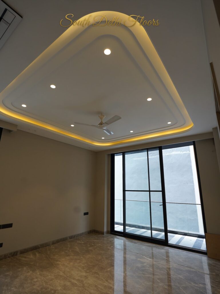 Bedroom with a sculpted triangular cove ceiling and black-framed window at an RPB Homes JCR Homes luxury builder floor in South Delhi by Mahavir Bihani and Rajat Bihani