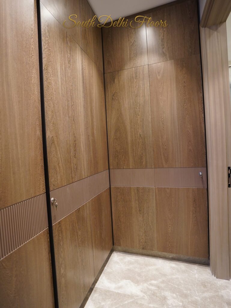 Walk-in closet with oak veneer panelled doors at an RPB Homes JCR Homes luxury home in South Delhi by builders Mahavir Bihani and Rajat Bihani