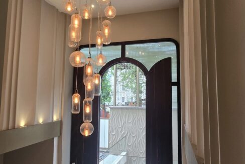 RS Buildtech Arched Main Door and Glass Globe Chandelier | Builder Ravinder Singh Marwah