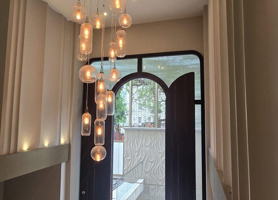 RS Buildtech Arched Main Door and Glass Globe Chandelier | Builder Ravinder Singh Marwah