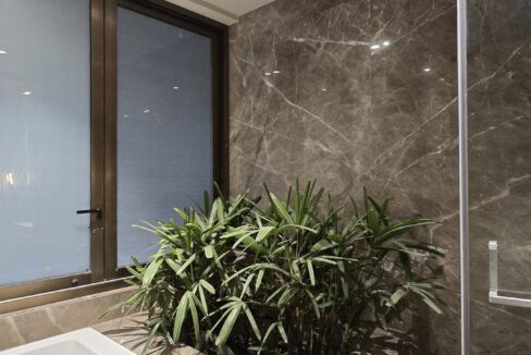 RS Buildtech Grey Marble Bathroom with Built-In Planter | Luxury Builder Floor by Ravinder Singh Marwah