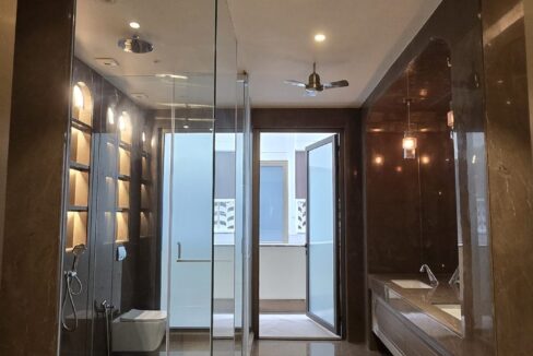 RS Buildtech Bathroom with Glass Shower and Balcony Door | Luxury Builder Floor by Ravinder Singh Marwah