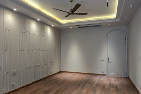 RS Buildtech Bedroom with Wooden Floor and Sculpted Wall | Developer Ravinder Singh Marwah