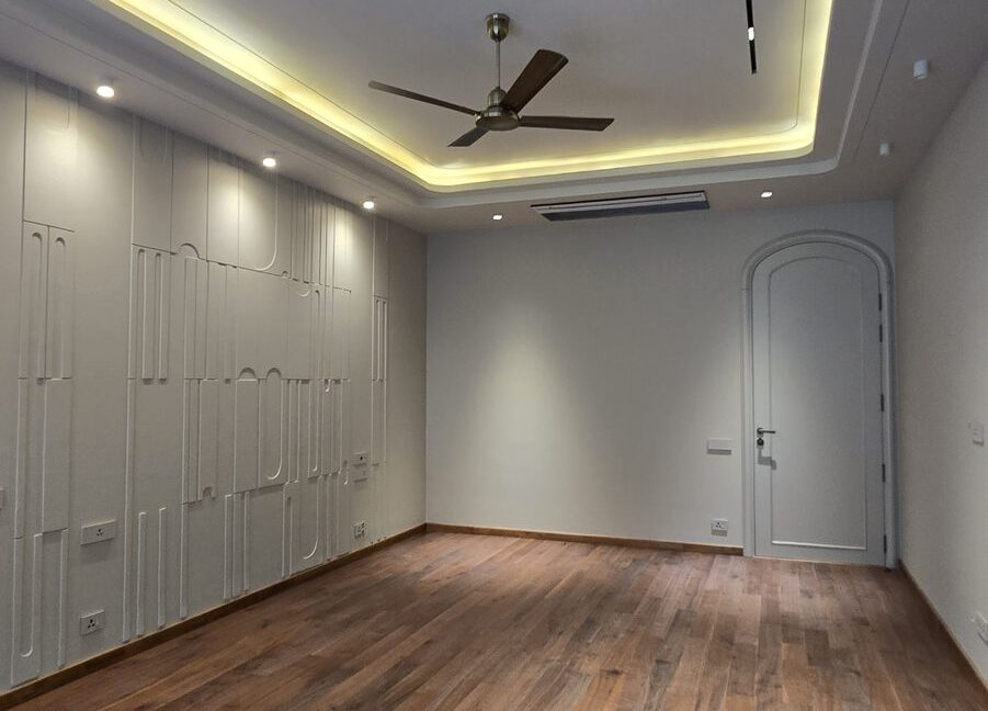 RS Buildtech Bedroom with Wooden Floor and Sculpted Wall | Developer Ravinder Singh Marwah