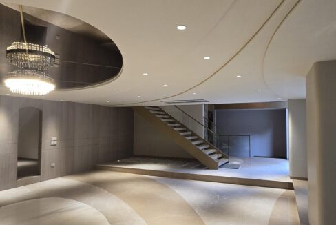 RS Buildtech Lounge with Crystal Chandelier and Floating Staircase | Luxury Builder Floor by Ravinder Singh Marwah