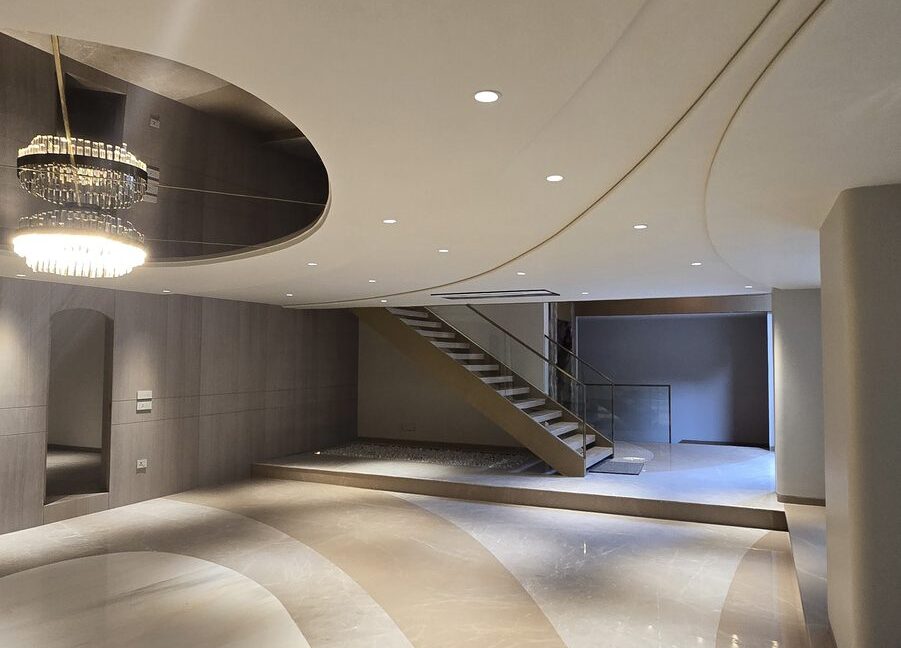 RS Buildtech Lounge with Crystal Chandelier and Floating Staircase | Luxury Builder Floor by Ravinder Singh Marwah
