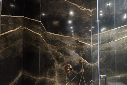 RS Buildtech Black and Gold Marble Walk-In Shower | Luxury Builder Floor by Ravinder Singh Marwah