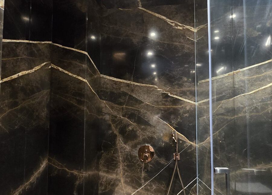 RS Buildtech Black and Gold Marble Walk-In Shower | Luxury Builder Floor by Ravinder Singh Marwah