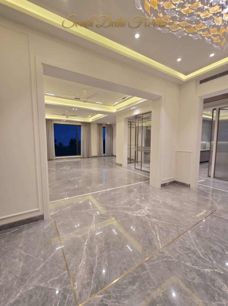 Dining room gold chandelier at night at a Windchimes Construction builder floor in South Delhi