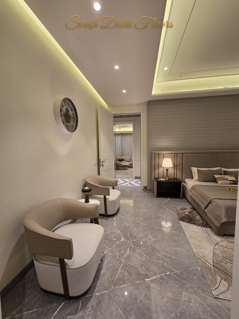 Bedroom sitting area armchairs at a Windchimes Construction builder floor in South Delhi