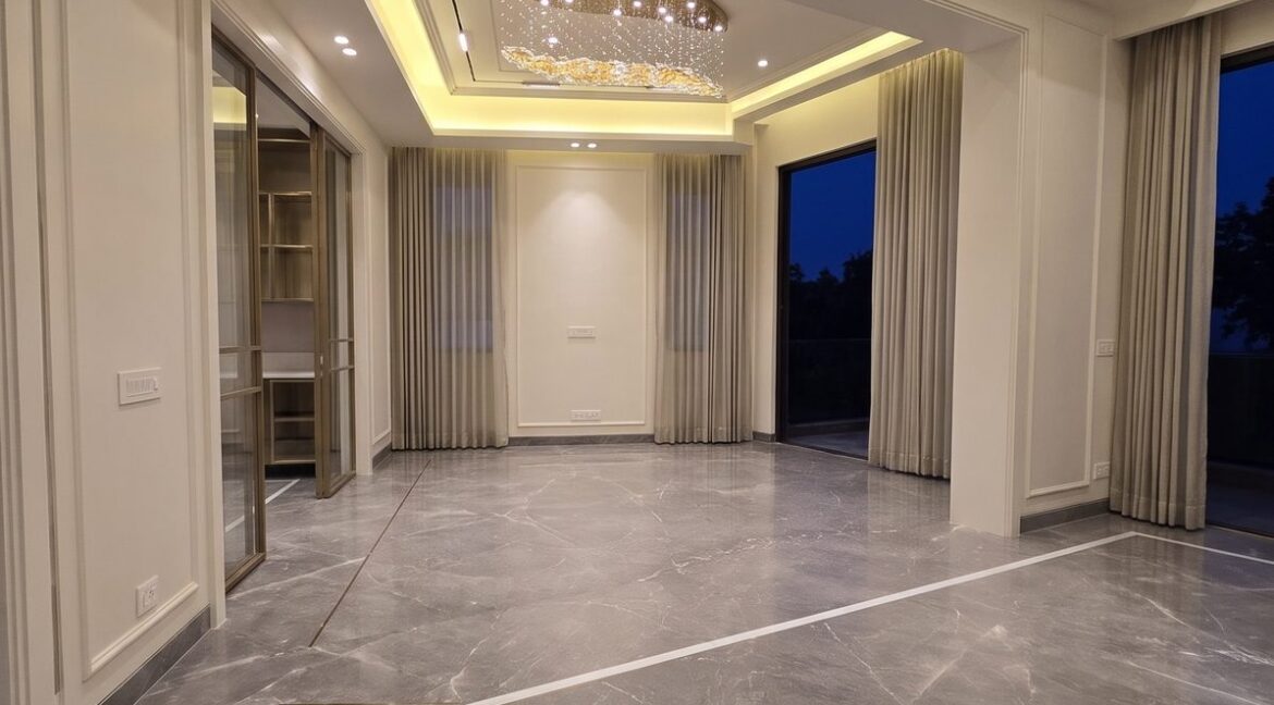 Windchimes Construction Empty Living Room Corner View At Night - Amrit Lal
