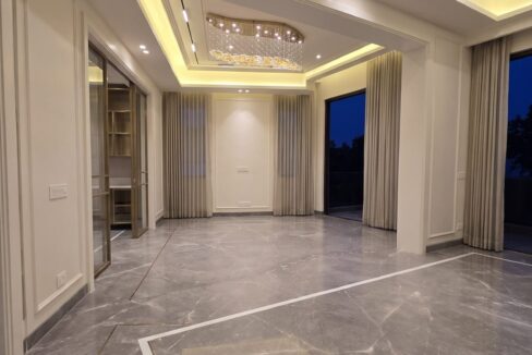 Windchimes Construction Empty Living Room Corner View At Night - Amrit Lal